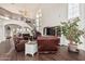 Bright living room boasts soaring ceilings, wood floors, and a staircase leading to the upper level at 1449 W Commerce Ave, Gilbert, AZ 85233