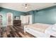 Large main bedroom features hardwood floors, ceiling fan, and adjoining bathroom at 1449 W Commerce Ave, Gilbert, AZ 85233