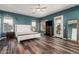 Serene main bedroom features wood floors, a ceiling fan, and a private balcony at 1449 W Commerce Ave, Gilbert, AZ 85233