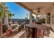 Inviting covered patio with comfortable seating and outdoor dining area, overlooking the pool and garden at 1449 W Commerce Ave, Gilbert, AZ 85233