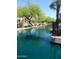 Scenic canal view featuring lush trees, vibrant blue water, and waterfront homes on a bright, sunny day at 1449 W Commerce Ave, Gilbert, AZ 85233