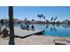 Picturesque waterfront homes with docks on a serene lake, lined with palm trees at 1449 W Commerce Ave, Gilbert, AZ 85233