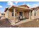 The back patio of this home features a dining table and a covered seating area at 1475 E Runaway Bay Dr, Chandler, AZ 85249
