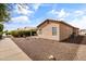 A view of the home's back yard and covered patio and minimal landscaping at 1475 E Runaway Bay Dr, Chandler, AZ 85249