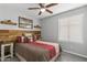 Inviting bedroom with a wood accent wall, comfortable bed, and plenty of natural light at 1475 E Runaway Bay Dr, Chandler, AZ 85249