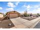 Beautifully landscaped house featuring a long driveway, well kept lawn, and lovely facade at 1475 E Runaway Bay Dr, Chandler, AZ 85249
