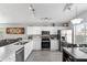 Bright kitchen with white cabinets, stainless steel appliances, and a spacious countertop with modern finishes at 1475 E Runaway Bay Dr, Chandler, AZ 85249