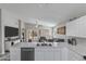 Open concept kitchen with a breakfast bar overlooking the living area and backyard access at 1475 E Runaway Bay Dr, Chandler, AZ 85249
