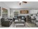 Cozy living room with a ceiling fan, comfortable seating, natural light, and a view of the kitchen area at 1475 E Runaway Bay Dr, Chandler, AZ 85249