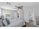 Comfortable main bedroom featuring a ceiling fan and access to the bathroom at 1475 E Runaway Bay Dr, Chandler, AZ 85249