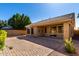 A charming backyard with a covered patio, stone pavers, and desert landscaping at 1552 E Shannon St, Chandler, AZ 85225