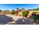 A landscaped backyard with a brick wall, stone pavers, and desert vegetation at 1552 E Shannon St, Chandler, AZ 85225