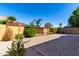 A paved backyard area surrounded by brick walls, landscaping, and lattice accents at 1552 E Shannon St, Chandler, AZ 85225
