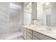 Bathroom featuring double sinks, a walk-in shower, and modern tile accents at 1552 E Shannon St, Chandler, AZ 85225