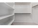 Bright walk-in closet with shelving and hanging rods for optimized storage at 1552 E Shannon St, Chandler, AZ 85225