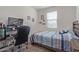 Simple bedroom with window offering plenty of natural light and desk at 16584 W Shangri La Rd, Surprise, AZ 85388