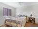 A peaceful bedroom showcases a comfortable bed, window with blinds, and a bookshelf at 1942 S Emerson -- # 127, Mesa, AZ 85210