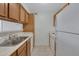This bright kitchen features white appliances, tile flooring and wooden cabinets at 1942 S Emerson -- # 127, Mesa, AZ 85210