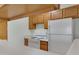 A functional kitchen includes essential appliances, wooden cabinetry, and ample counter space at 1942 S Emerson -- # 127, Mesa, AZ 85210