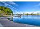 Scenic lake view featuring a pier, lush trees, and blue skies, offering a serene and picturesque outdoor setting at 1942 S Emerson -- # 127, Mesa, AZ 85210