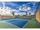 Community pickleball court featuring blue courts, bright lighting and palm trees on a sunny day with puffy white clouds at 1942 S Emerson -- # 127, Mesa, AZ 85210