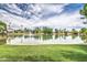 Scenic pond surrounded by green grass and neighborhood homes reflecting in the waters at 1942 S Emerson -- # 127, Mesa, AZ 85210