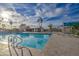Community pool featuring lounge chairs and picnic tables beneath a gazebo and tropical palm trees surrounding the fenced area at 1942 S Emerson -- # 127, Mesa, AZ 85210