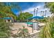 Palm tree-lined community pool featuring lounge chairs, tables and umbrellas under a bright blue sky at 1942 S Emerson -- # 127, Mesa, AZ 85210