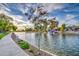 Scenic waterfront view featuring a tree, homes, and boats along the serene canal, highlighting a peaceful neighborhood setting at 1942 S Emerson -- # 127, Mesa, AZ 85210