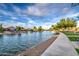 Tranquil waterfront view of homes along the canal with a scenic sidewalk and lush landscaping, perfect for leisurely strolls at 1942 S Emerson -- # 127, Mesa, AZ 85210