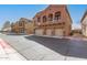 Attractive townhome with a 3-car garage, balcony, and desert landscaping at 2024 S Baldwin St # 161, Mesa, AZ 85209