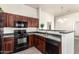 This kitchen is equipped with stainless steel appliances and dark wood cabinets providing ample storage at 2024 S Baldwin St # 161, Mesa, AZ 85209