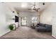 Well-lit living room with a ceiling fan and sliding doors to a balcony at 2024 S Baldwin St # 161, Mesa, AZ 85209