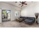 Cozy living room featuring a modern sofa and sliding glass doors to a balcony at 2024 S Baldwin St # 161, Mesa, AZ 85209