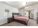 Spacious main bedroom boasts a ceiling fan, sliding glass door to the balcony, and neutral decor at 2024 S Baldwin St # 161, Mesa, AZ 85209