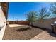 Low maintenance backyard with gravel, block wall, and brick-lined patio, ideal for relaxed outdoor living and entertaining at 2116 S 238Th Ln, Buckeye, AZ 85326