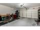 Spacious garage with a large door, workbench, and overhead lighting at 2116 S 238Th Ln, Buckeye, AZ 85326