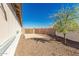 Side yard has a gravel ground cover and a gate to the backyard at 2116 S 238Th Ln, Buckeye, AZ 85326