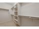 Walk-in closet features shelving and hanging rods for maximum storage and organization at 21281 N 270Th Dr, Buckeye, AZ 85396
