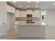 Well-lit kitchen with white cabinets, stainless steel appliances, and a center island at 21281 N 270Th Dr, Buckeye, AZ 85396