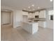 Spacious kitchen with white cabinets, stainless steel appliances, and a large center island at 21281 N 270Th Dr, Buckeye, AZ 85396