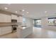 Open concept kitchen with white cabinets, stainless steel appliances, and a center island at 21281 N 270Th Dr, Buckeye, AZ 85396