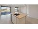 Kitchen island boasts a sink, stainless steel dishwasher, and ample counter space at 21281 N 270Th Dr, Buckeye, AZ 85396