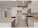 Modern kitchen featuring a large island with sink, stainless steel appliances, and white cabinetry at 21281 N 270Th Dr, Buckeye, AZ 85396
