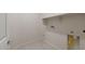 Functional laundry area with connections for washer and dryer, and a mounted shelf at 21281 N 270Th Dr, Buckeye, AZ 85396