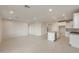 Bright living room with tile flooring, recessed lighting, and an open layout to the kitchen at 21281 N 270Th Dr, Buckeye, AZ 85396