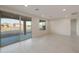 Spacious living room features tile flooring, recessed lighting, and sliding glass doors to the patio at 21281 N 270Th Dr, Buckeye, AZ 85396
