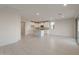 Open-concept floorplan with bright living area and seamless flow to the well-appointed kitchen at 21281 N 270Th Dr, Buckeye, AZ 85396
