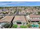 Expansive aerial view showcasing a home with a pool, manicured lawns, and a well-maintained community at 2483 E Narrowleaf Dr, Gilbert, AZ 85298