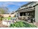 Inviting covered patio with a dining area, seating, and a cozy fire pit, perfect for outdoor entertaining at 2483 E Narrowleaf Dr, Gilbert, AZ 85298